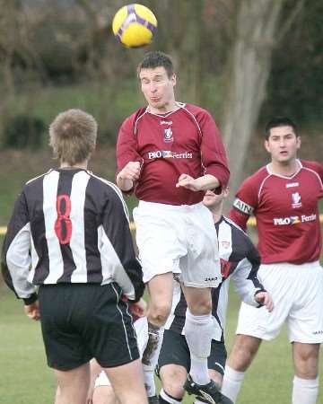 A Canterbury City player goes up for a header