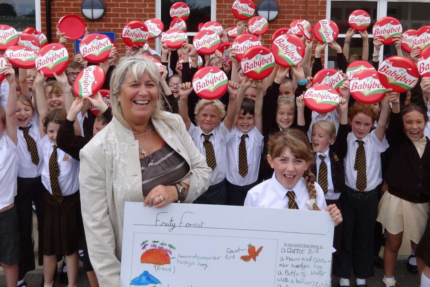 Teacher Mrs Dalton congratulates her pupil Florence Kenny, 9, from St Mary's Catholic Primary School in Whitstable for winning the KM Charity Team's Perfect Packed Lunch Awards 2014