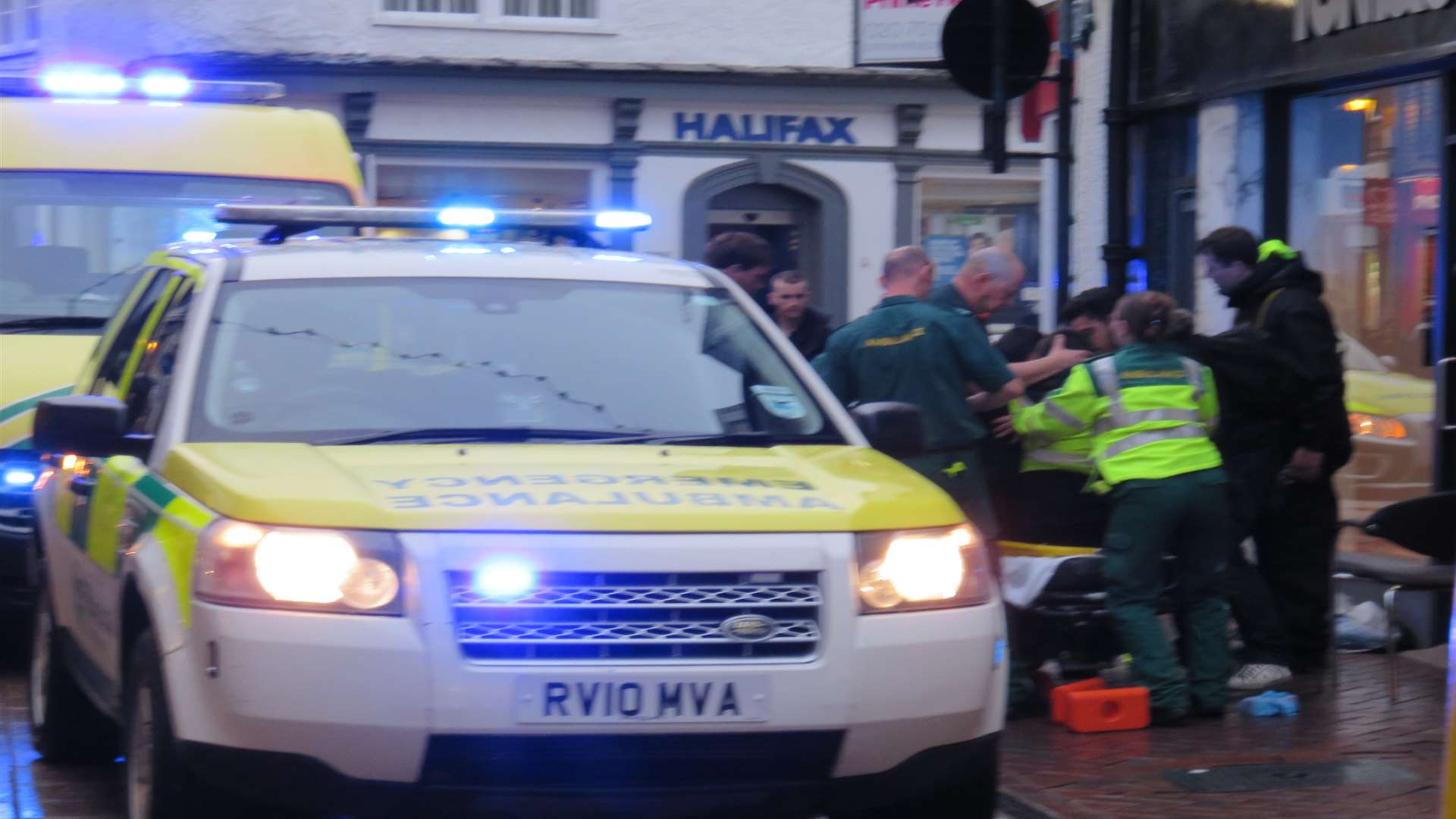 Paramedics help a man who fell while putting up Christmas lights in Ashford. Picture: Andy Clark