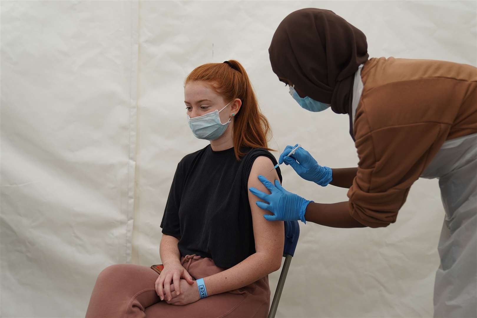 A woman receives a Covid-19 jab at a pop-up centre during the four-day vaccine festival in Langdon Park, Poplar, east London (Kirsty O’Connor/PA)