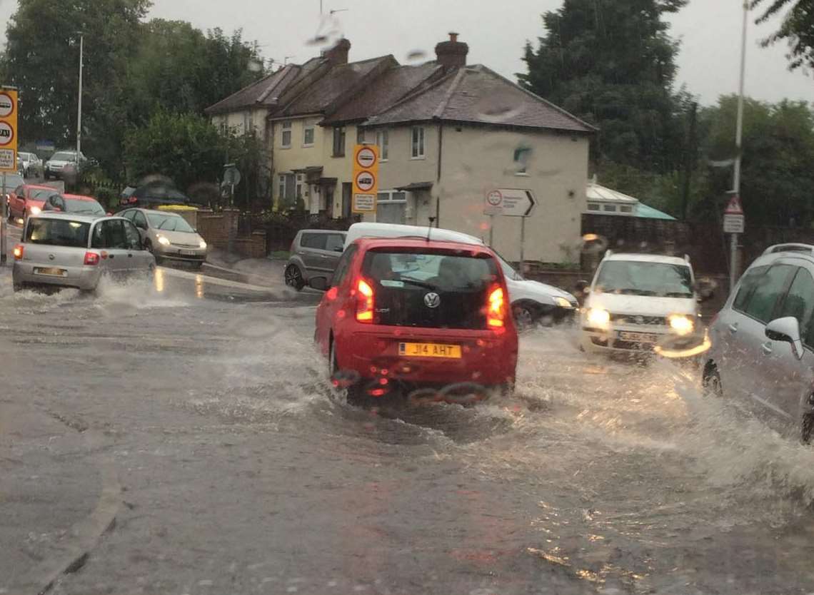 Cars carefully negotiate flood water in Darnley Road, Strood. Picture: Justine Church