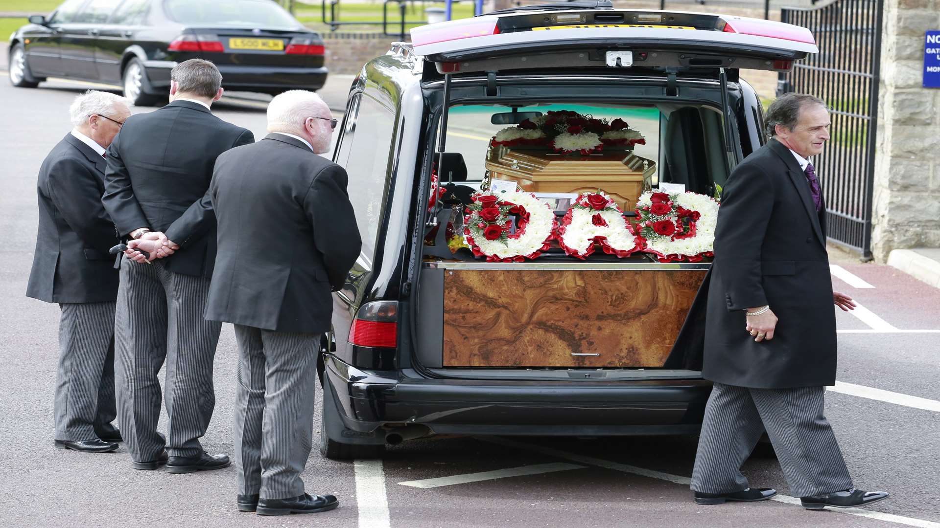 Mr Acott's coffin was transferred into a hearse for the final part of his journey. Picture: Martin Apps