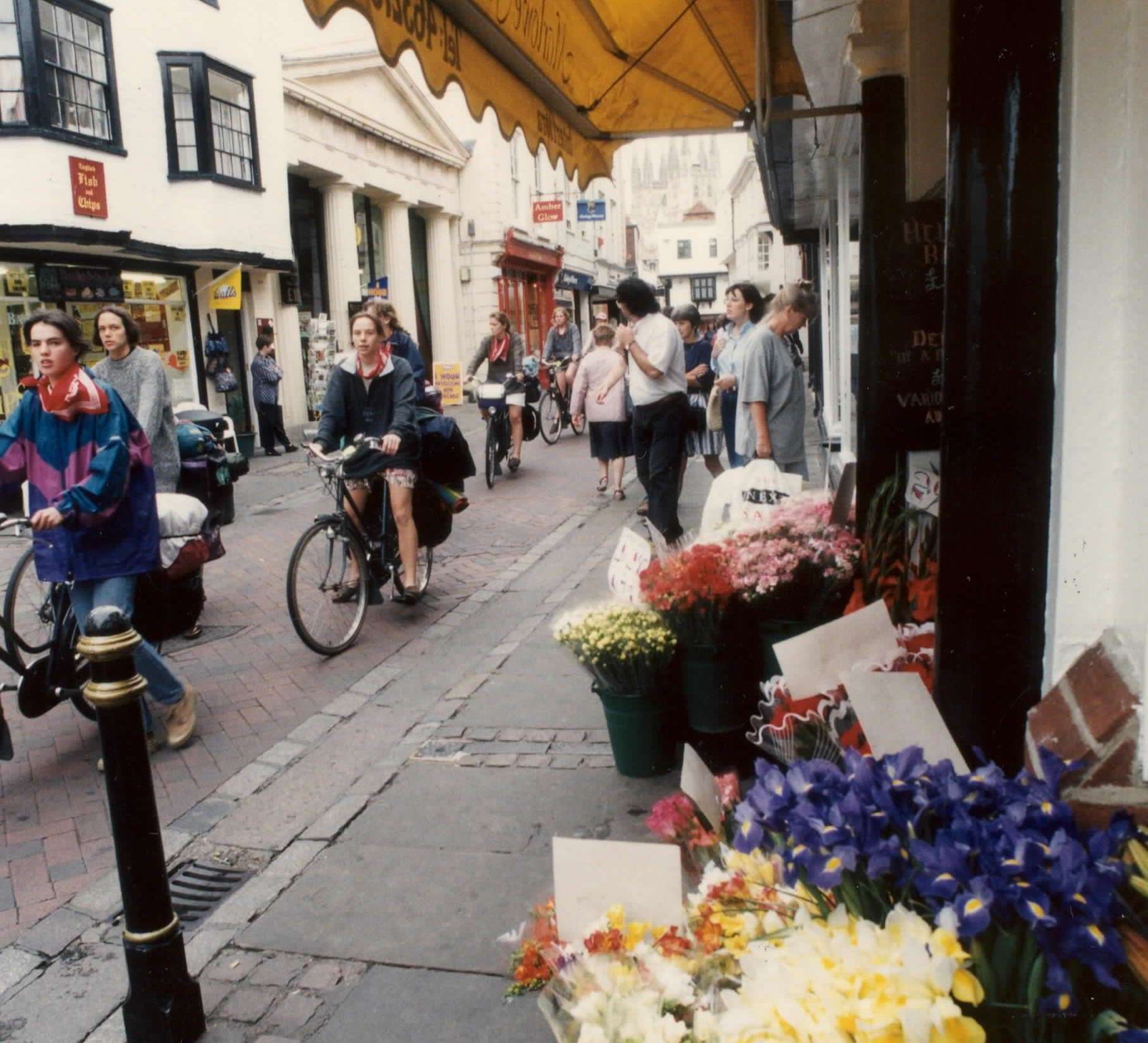St Margaret's Street, Canterbury, in 1996. The Amber Glow shop has since become Angel’s body piercing studio, while the premises next door is now occupied by L’Occitane boutique. The bouquets on the right of the picture were being sold by Interflora Flowers World Wide which has since been replaced by Marlowe Florists.