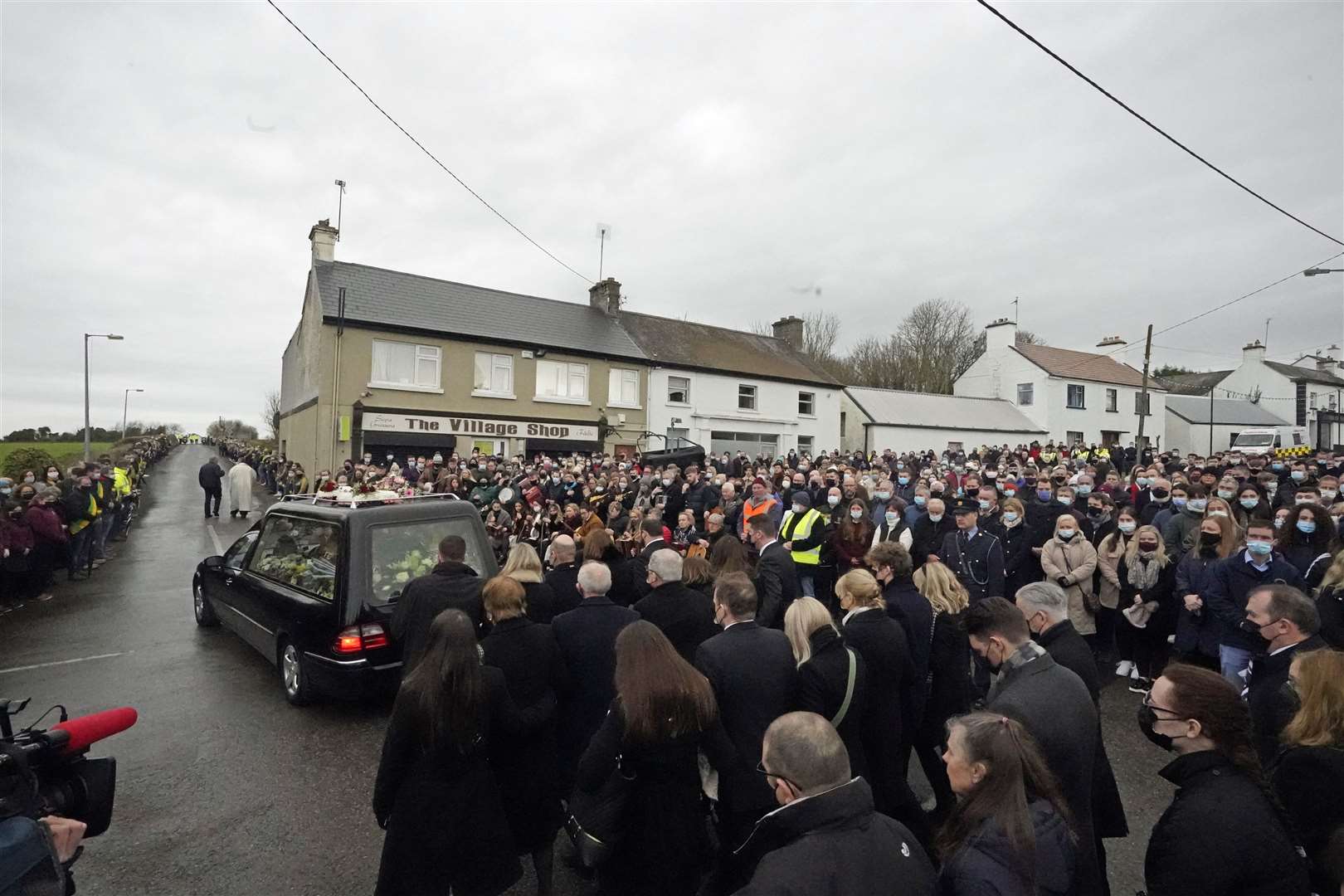 Ashling Murphy’s family and mourners walk behind the hearse as it leaves St Brigid’s Church, Mountbolus, Co Offaly on Tuesday (Niall Carson/PA)