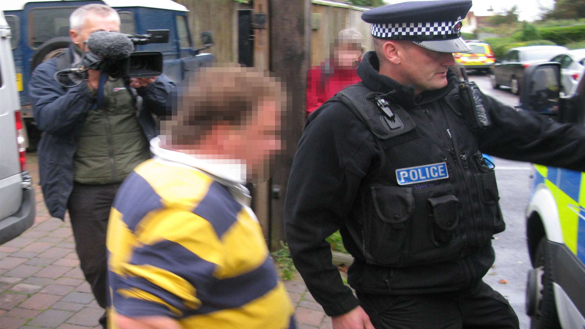 Darrell Houghton is arrested on suspicion of human trafficking under the full glare of cameras