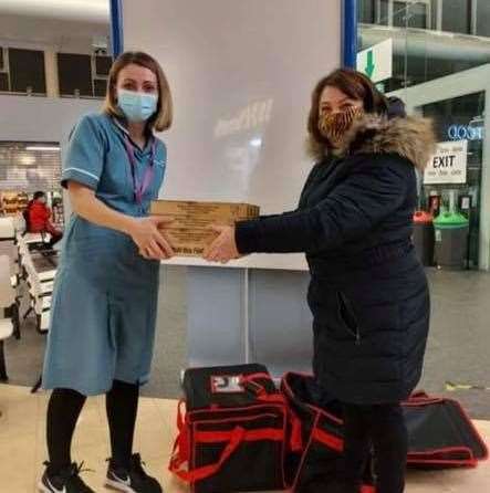 Dee Phillips handing food from The Bird in Hand pub to staff at Darent Valley Hospital in Dartford