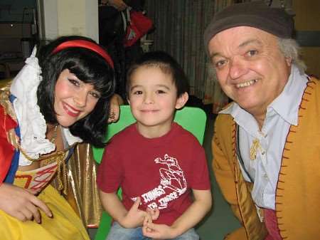 BIG DIFFERENCE: Claire Huckle as Snow White and Rusty Goffe as Grumbles meet Richard Herron, aged four. Picture: LUKE HOLLANDS