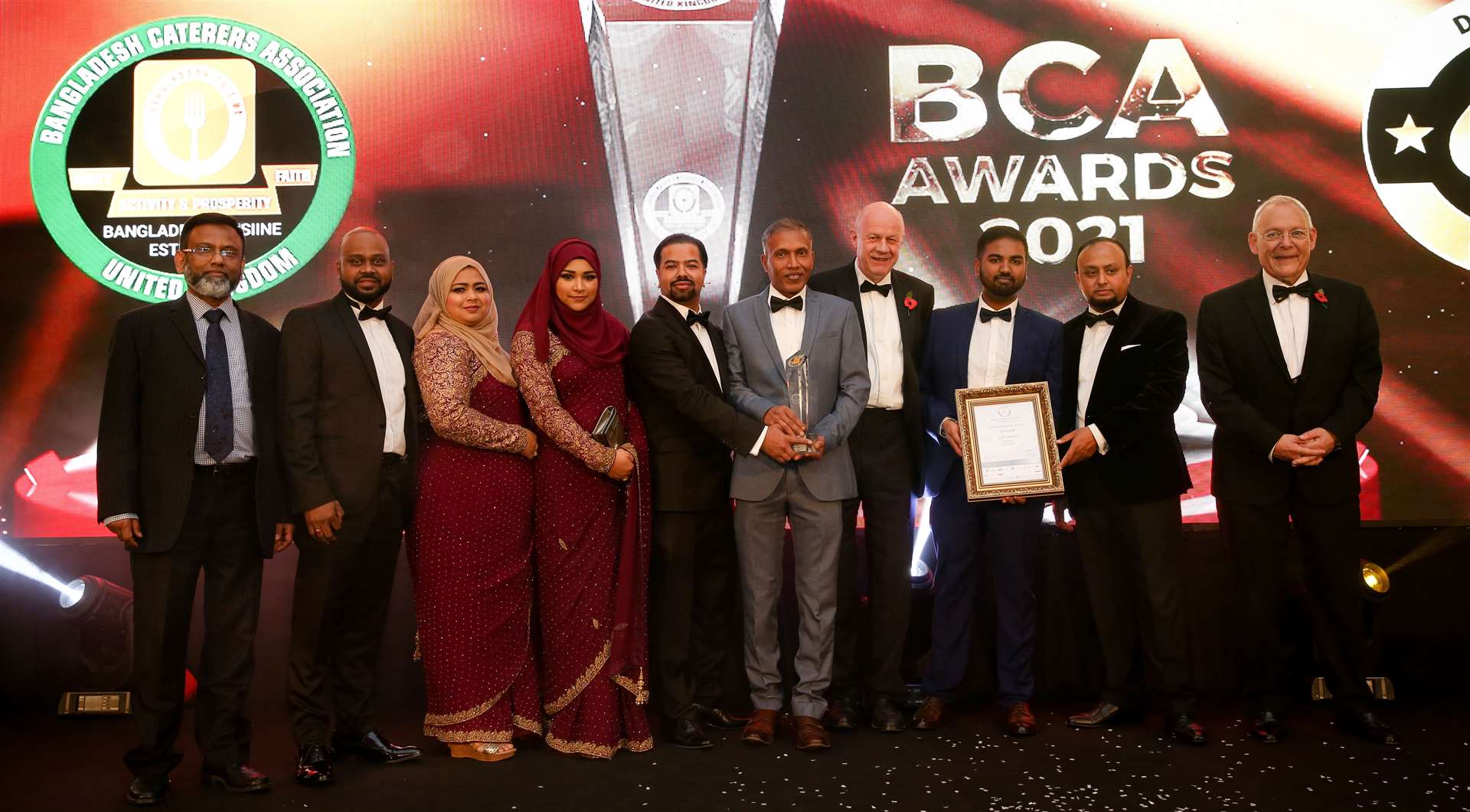 Staff at Cinnamon Spice collecting their award presented by MP Damian Green. Picture: BCA