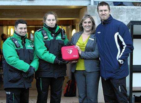 St John Ambulance volunteers Philip Winchester and Jo Eade presenting the defibrillator to DFC representatives Clare Weeks and First Team Captain, Elliot Bradbrook