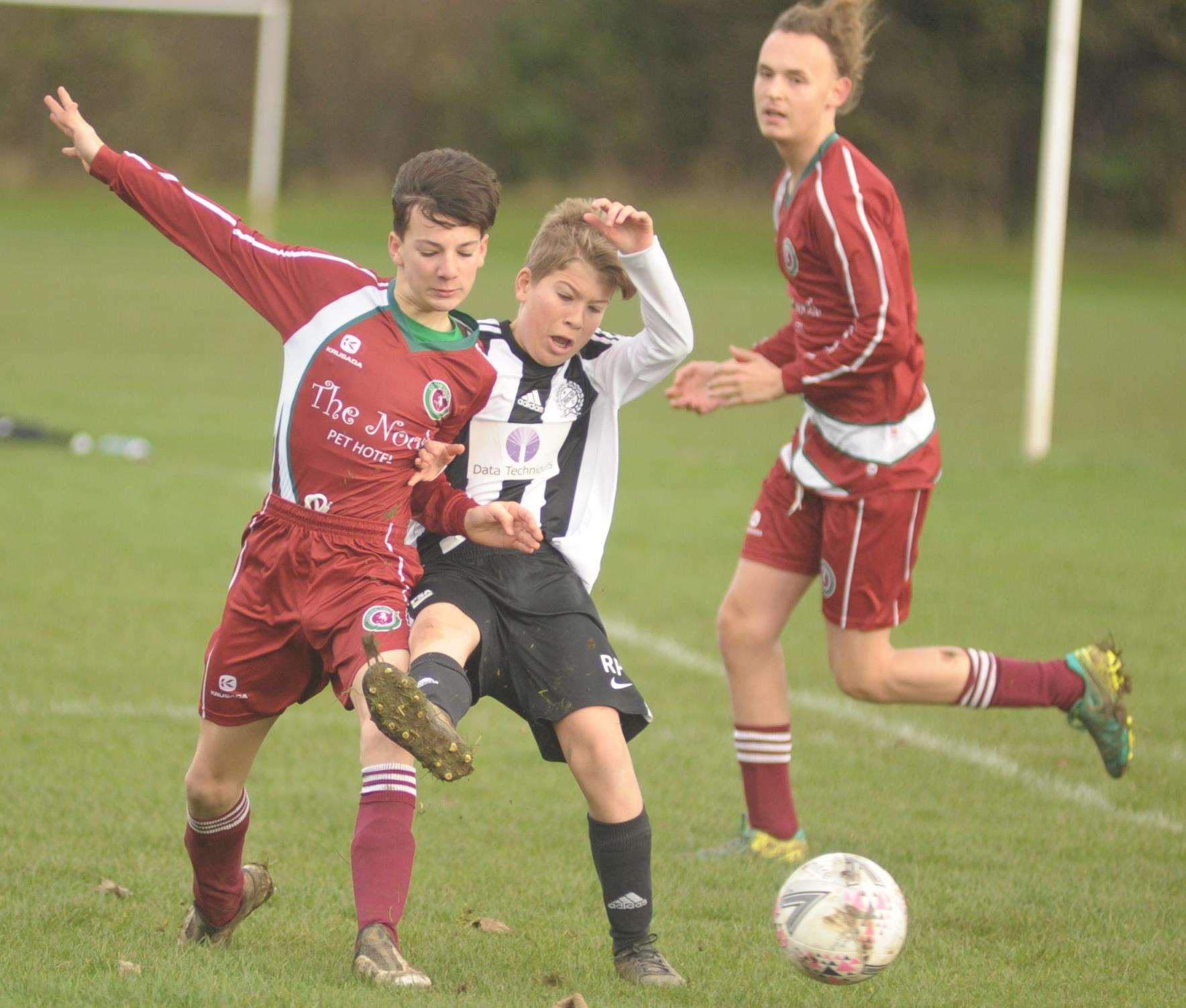 Under-15 sides Real 60 Lynx (stripes) and Cobham Colts battle for the points in Division 2 Picture: Steve Crispe