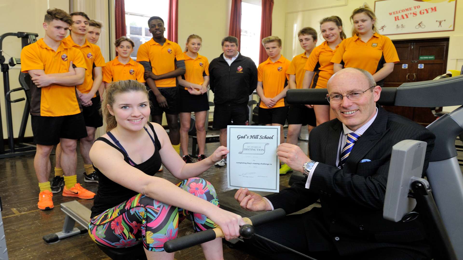 Lizzie Massey gets her certificate from Head Teacher, David Craggs, for winning the 100m challenge.