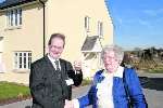Tom Wratten receives the keys to his new home from Mrs May Fortescue