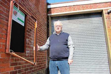 Chairman Dave Hake shows the damage to the notice board