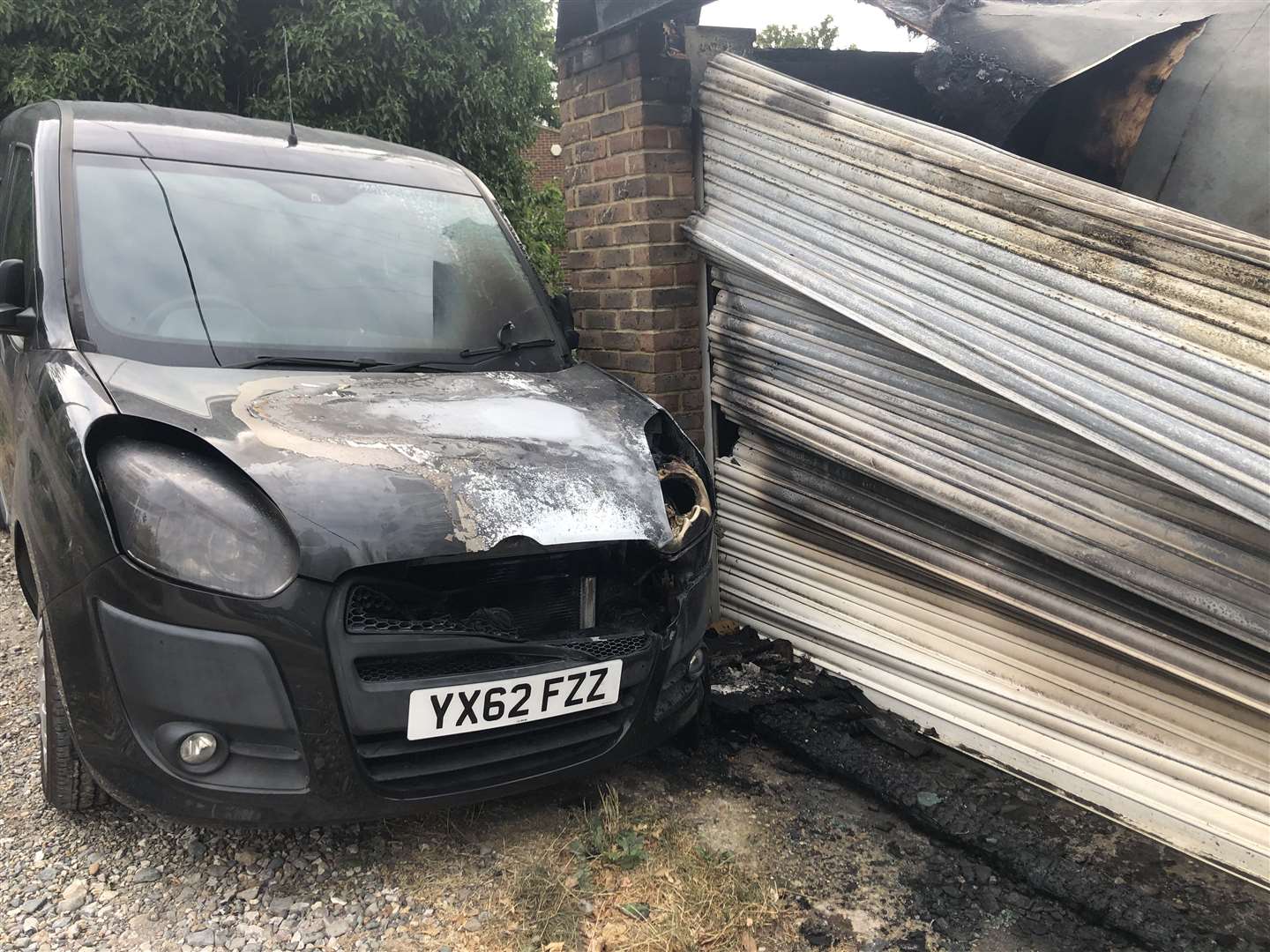A car parked outside has also been burnt