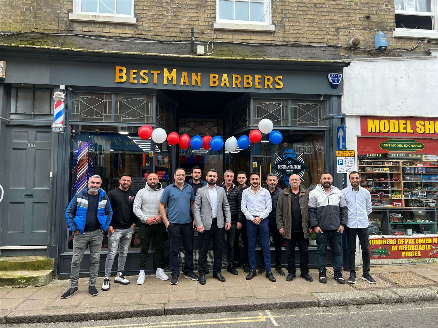 Berkan Yakit, pictured centre in grey jacket, says he is more determined than ever to make BestMan Barbers in Hythe High Street a success