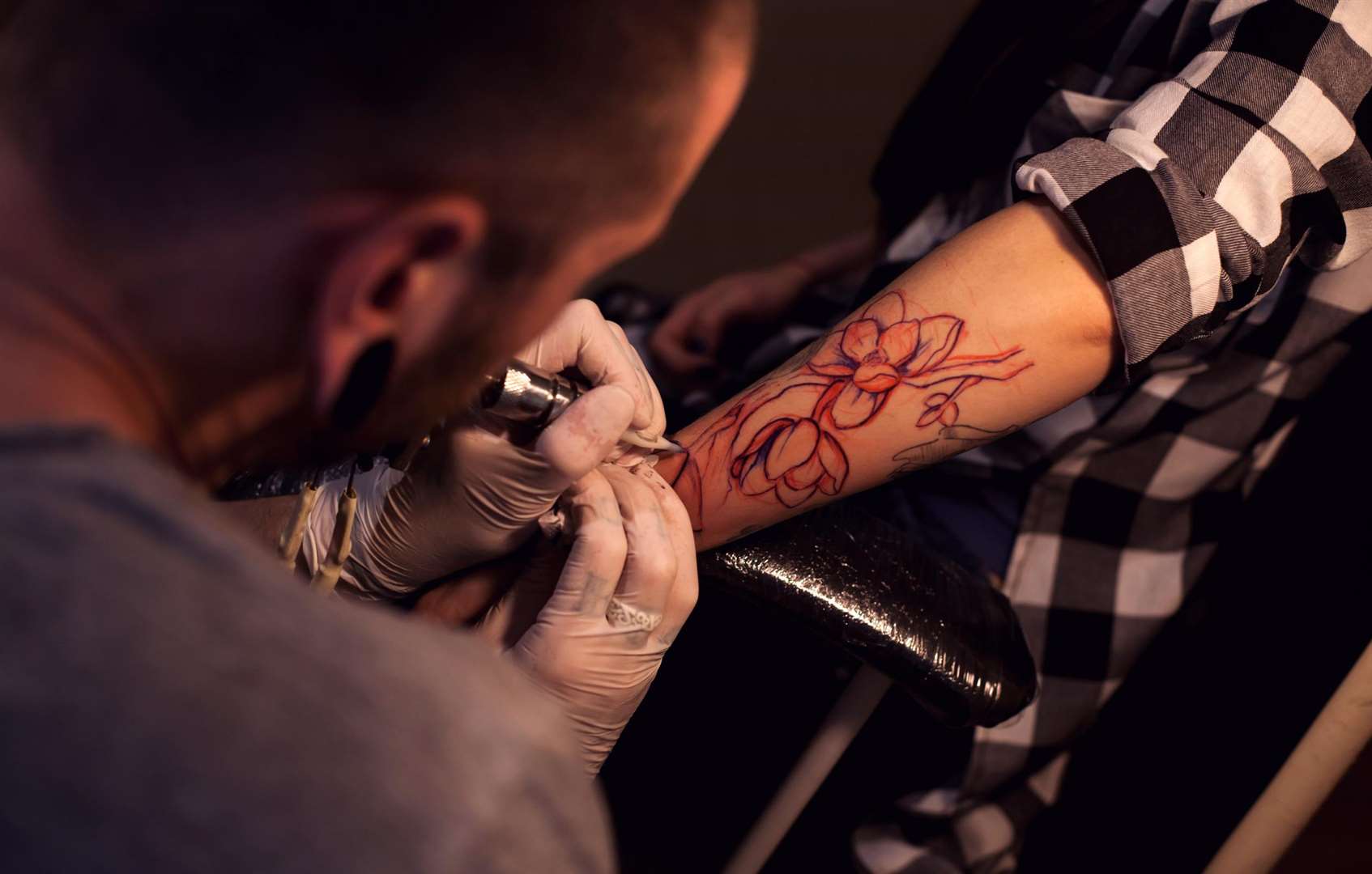Watch tattoo artists in action