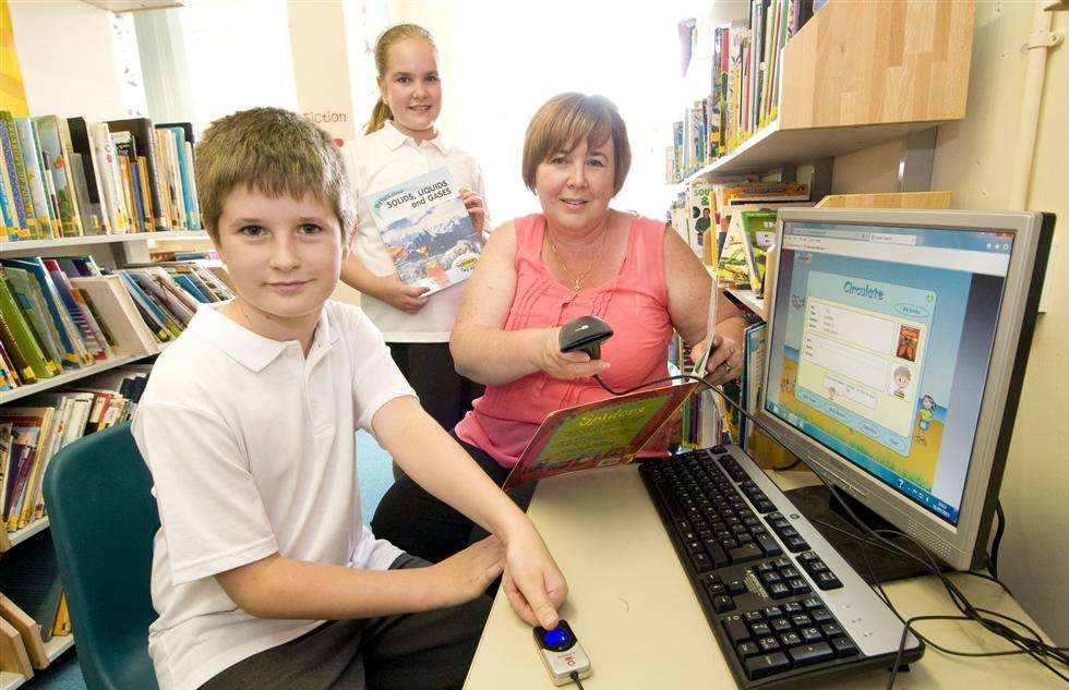Iwade Primary school showing off its fingerprint technology for kids to access the library. Twins, Katie and Ben Adams (10) are pictured demonstrating how it works with librarian and TA, Christina Ivory.