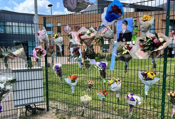 Flowers and tributes to Tristan outside his school