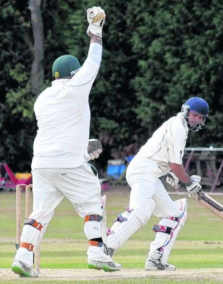 Ashford wicketkeeper Gavin Hope celebrates catching Canterbury's Neil Gower for 25