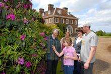 Lady Kingsdown and visitors the Cox family admire the rhododendrons.