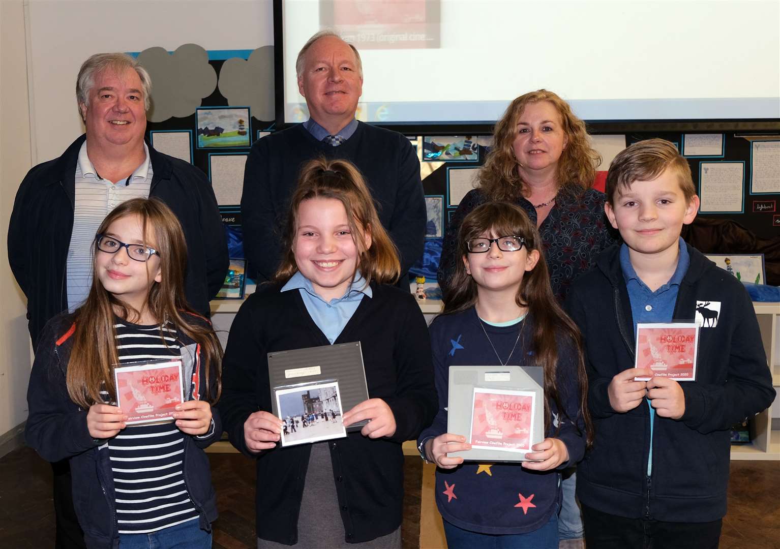 Ex pupils (Back left to right) Ian Brenton, David Brenton, Jane Williams with the pupils who put the film together (Bottom left to right) Hattie Gooding, Katy Gooch, Matilda Gooding, Owen Knight. Picture: Robin Halls