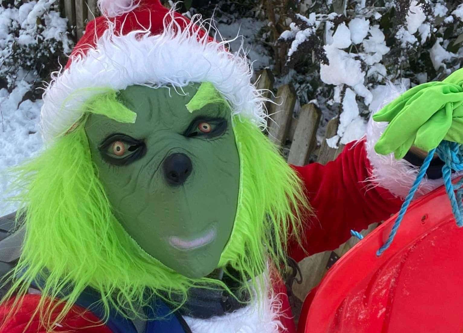 Daniel Wood has been doing the school run dresses as the Grinch