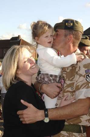 Welcome home. Sgt Andy Hainge kisses daughter Iona and gets a hug from wife Lynn