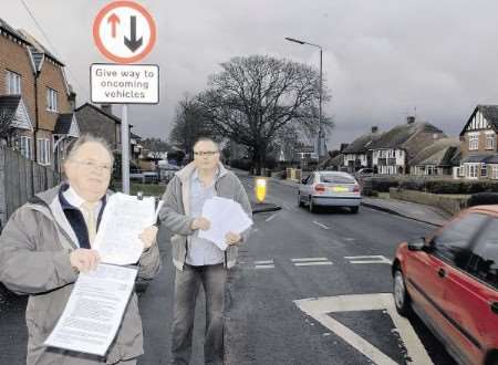 Action group organiser Tony Monk, left, and Cllr Brian Mortimer with a petition at a traffic calming point in Heath Road