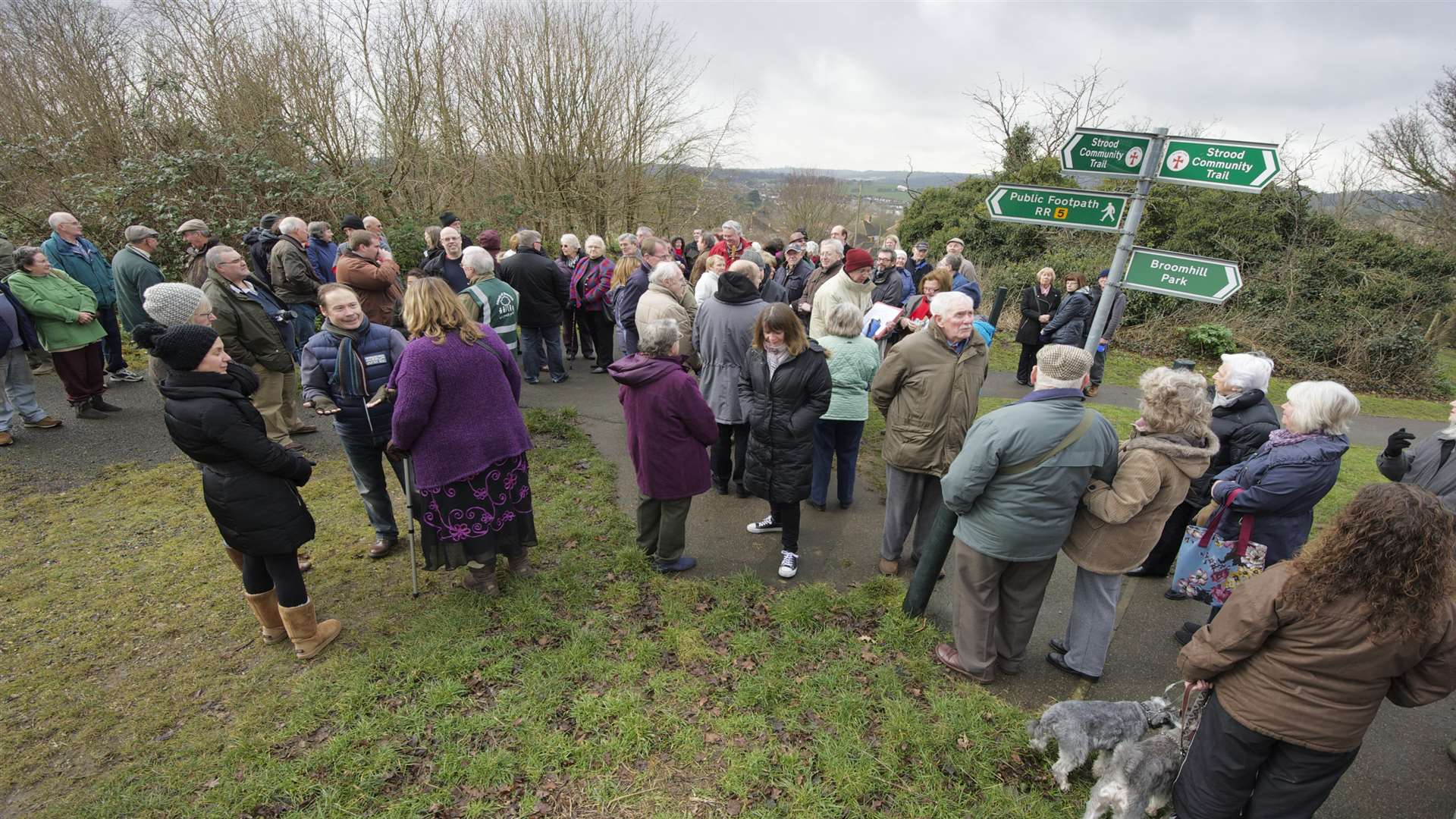 People gather at the site of the planned houses