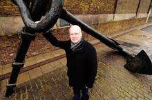 Andy Brown, of Minster Rotary Club, with the Victorian anchor in High Street, Blue Town