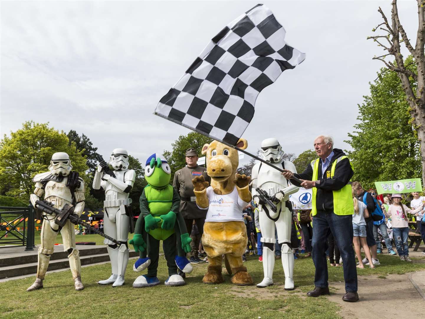 Martin Vye of the KM Charity Team waved the chequered flag while UK Garrison Stormtroopers, Buster Bug, and Gerald Giraffe headed up the record-breaking walking bus. (1969084)