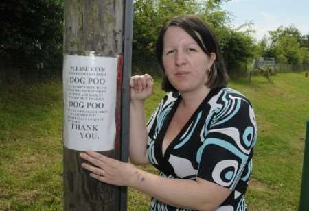 Toni Tyrell and one of her signs asking people to clean up after their dogs. Picture: Paul Amos