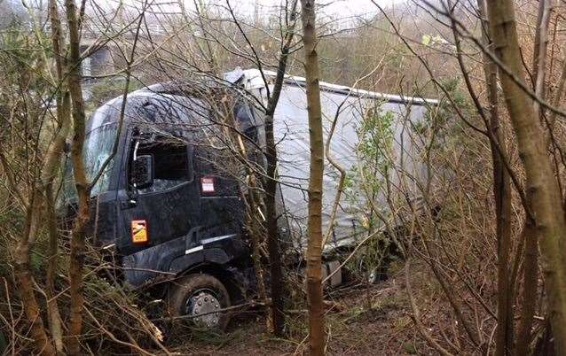 The lorry buried in undergrowth near the Lord Lees Roundabout at the top of Blue Bell Hill. Picture: Mike Mahoney