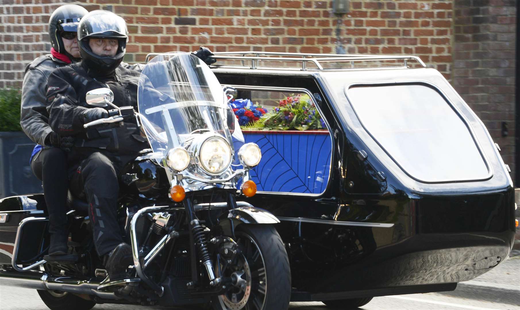 Sam's coffin, decorated in Spiderman colours, was carried in a sidecar