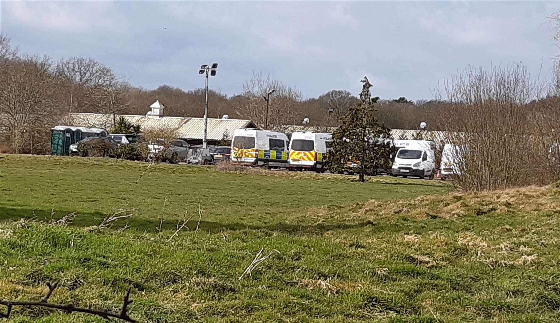Police vehicles parked on the former car park on Thursday morning