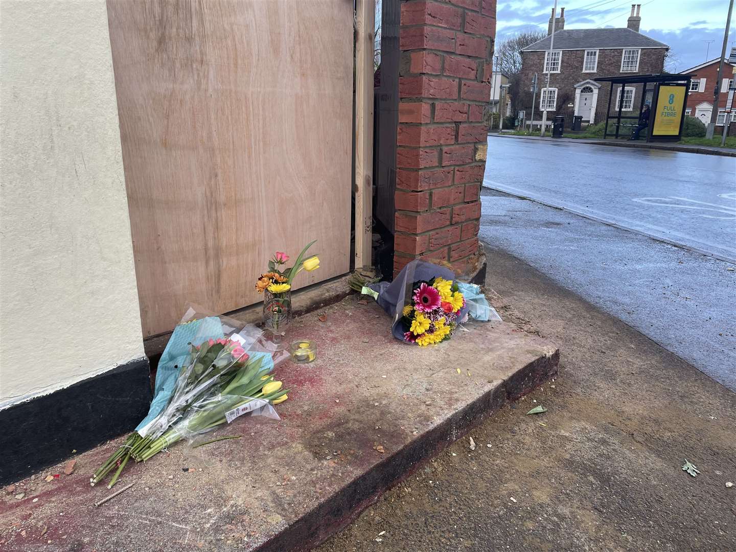 Floral tributes at the doorstep of the takeaway, opposite what Mrs Stokes describes as a "vicious corner"