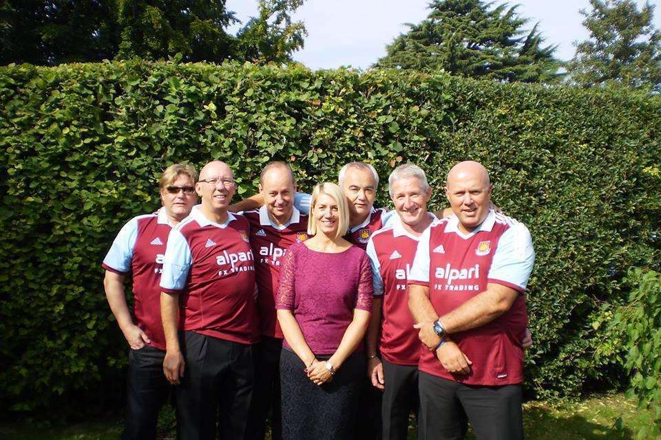 Nigel Kemp (second from left) and friends wore West Ham shirts to the funeral of friend Steve Ackhurst who died from Motor Neurone Disease. Steve's widow, Julie, is also pictured. .