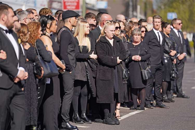 Mourners watch as the coffin of The Wanted star Tom Parker is carried ahead of his funeral. Picture: Kirsty O’Connor/PA