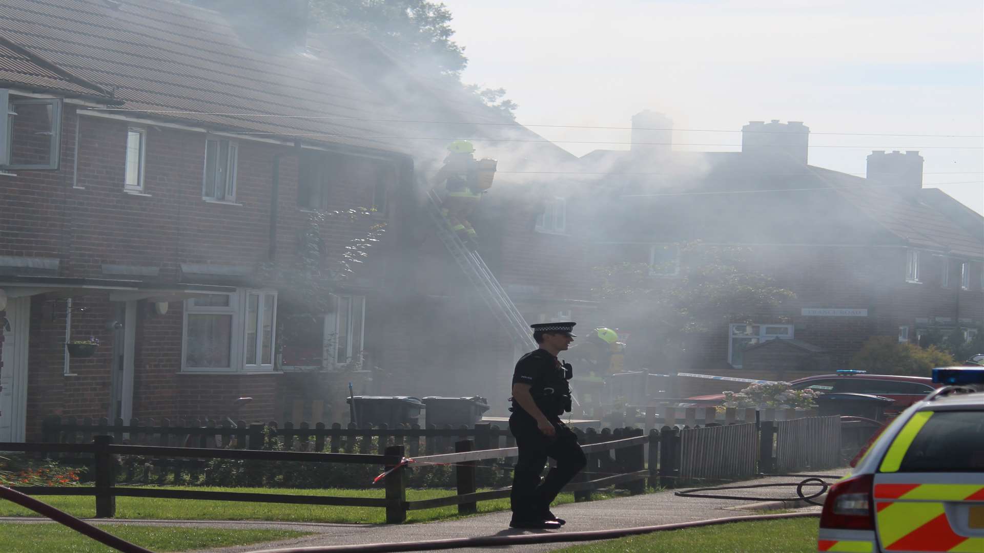 Smoke pours from a terraced house on fire in Whitfield near Dover