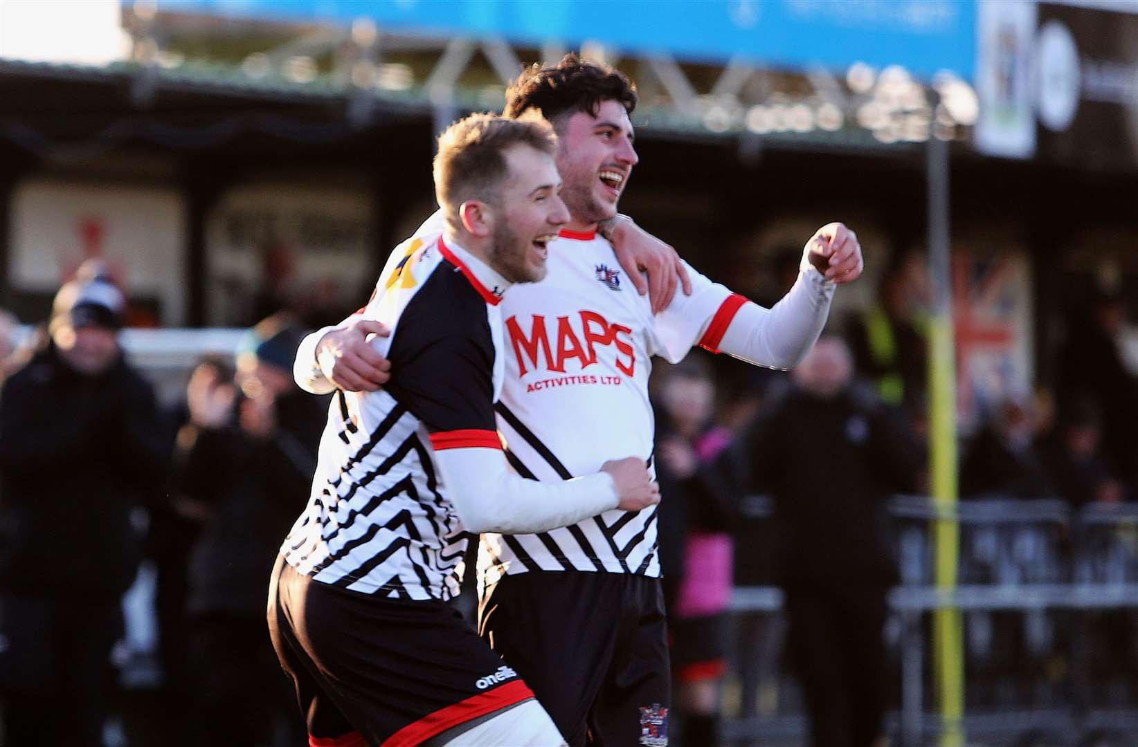 Jack Penny celebrates with a Deal team-mate after one of his corner-kick goals. Picture: Paul Willmott