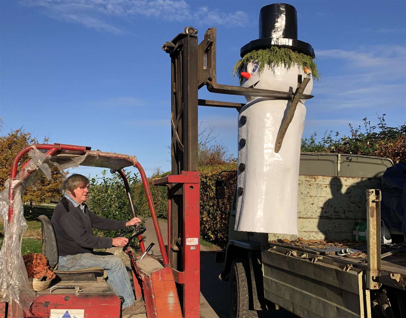 Boris the snowman being moved into place on a forklift
