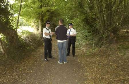 CRIME SCENE: PC Rob Jackson and PCSO Sandra Price speak to an innocent user of the footpath where the alleged offence happened. Picture: BARRY CRAYFORD