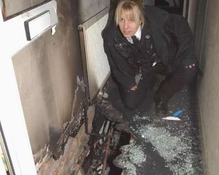 PC Vicky Strila inspecting the fire damage at the house. Picture: BARRY CRAYFORD