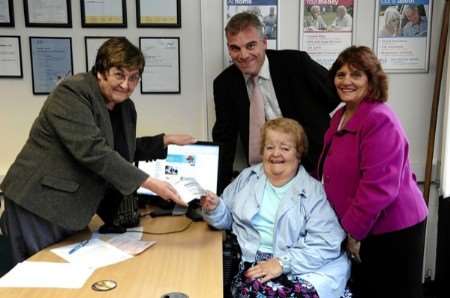 The first travel voucher is handed out. (l-r) Scheme organiser Linda Amuro, Cllr Chris Garland (Con), Pauline Breach and chairman of Age Concern Maidstone, Pat Thomas. Photography by Matthew Walker
