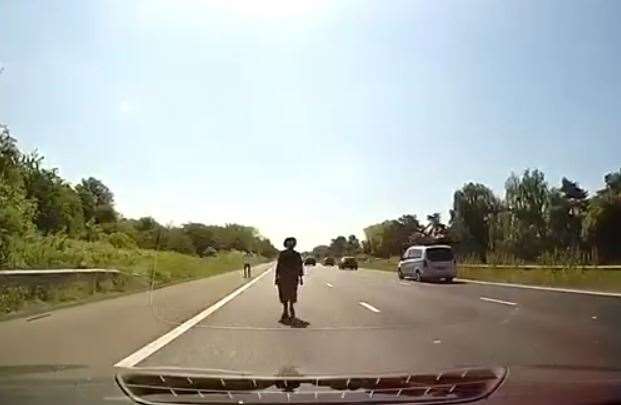 Two people were caught on camera walking on the M20 just south of Ashford