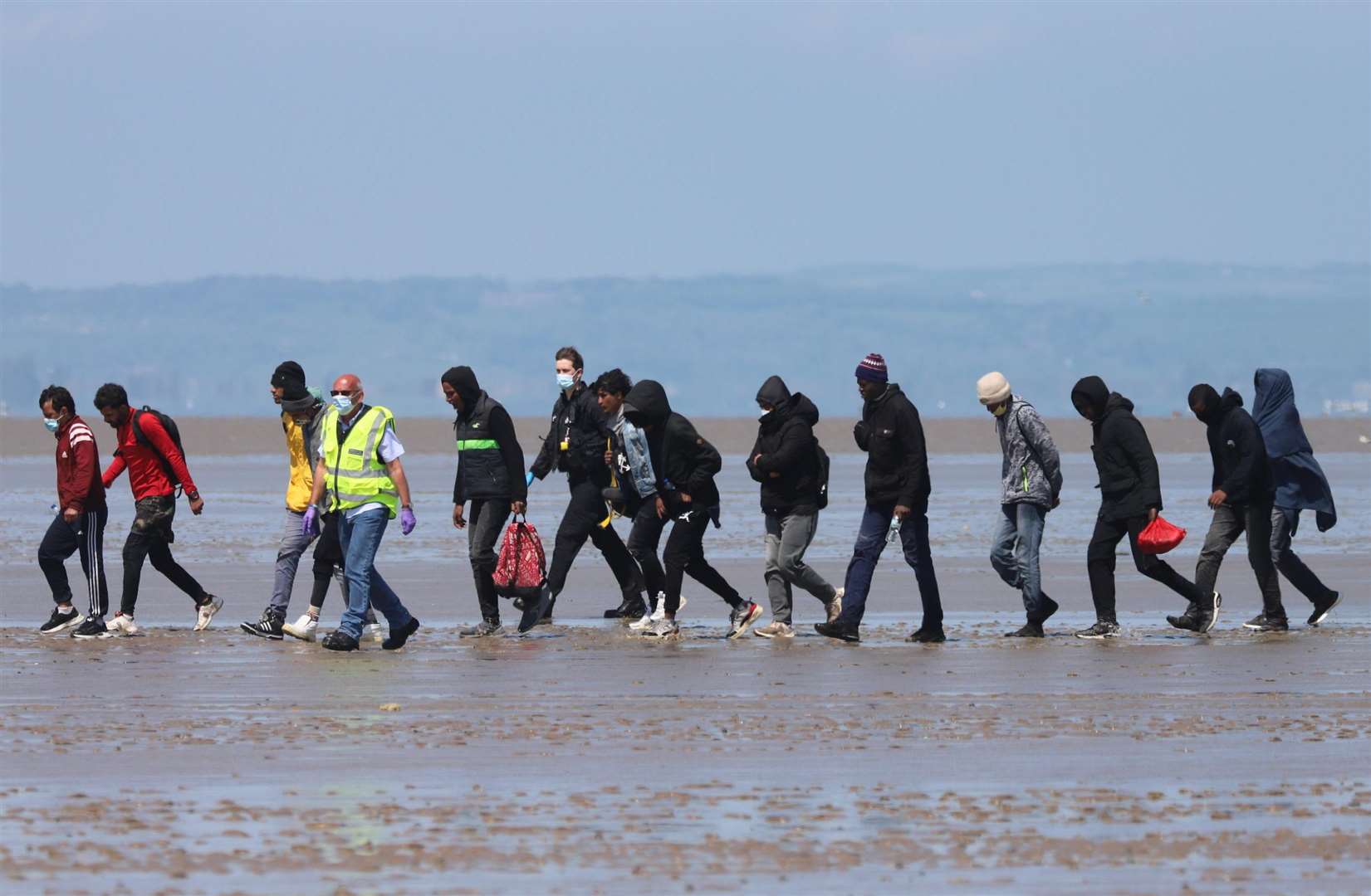 12 asylum seekers with two officials at Romney Marsh. Submitted picture