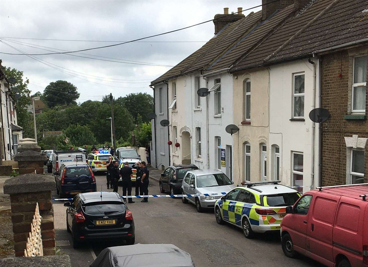 The street has been taped off after it is believed a knife was thrown into a nearby garden