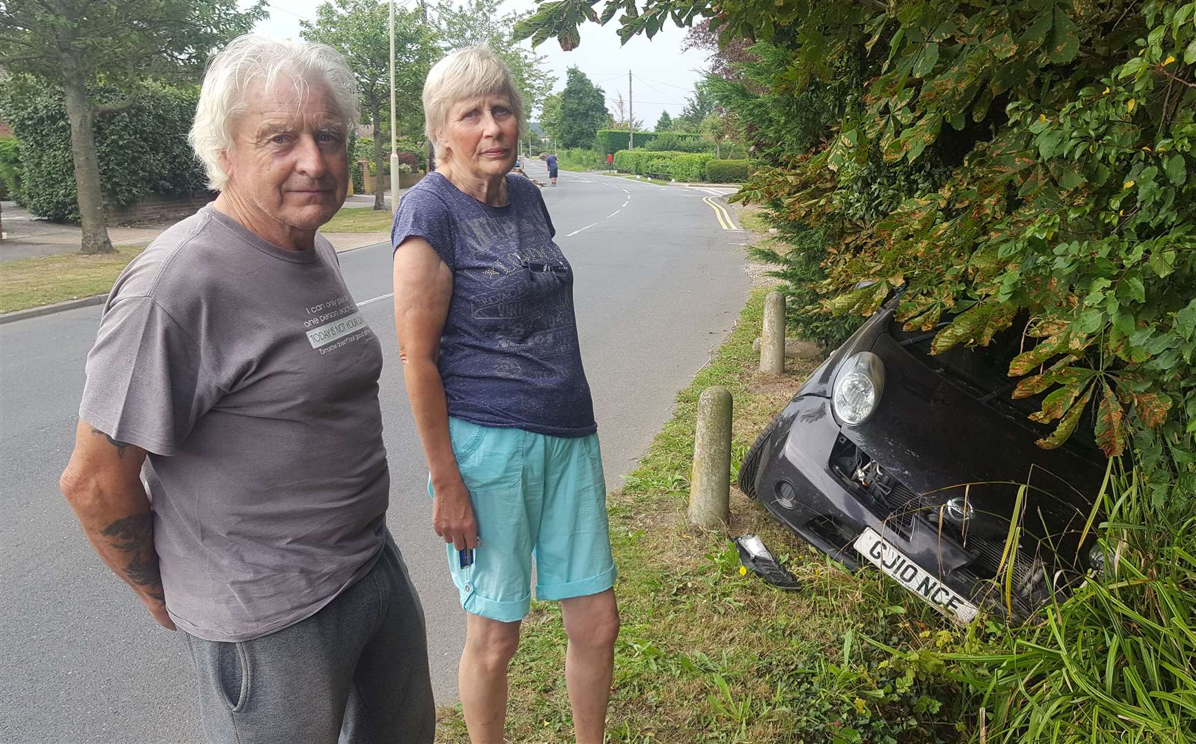 Former parish councillors George and Lyn Gadd next to the crash car