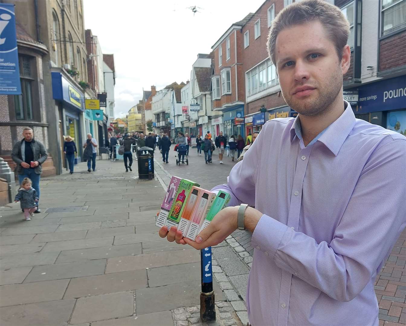 KentOnline's Jack Dyson holding the illegal vapes in the centre of Canterbury's high street