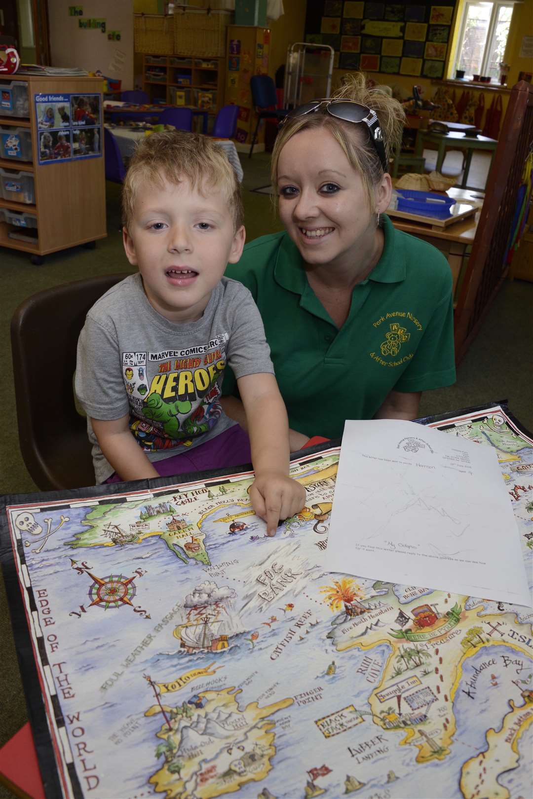 Park Avenue Nursery, four year old Harrison Keeley point out where his bottle might have been found on a Pirate map to Nursery Assistant Cheryl Duke